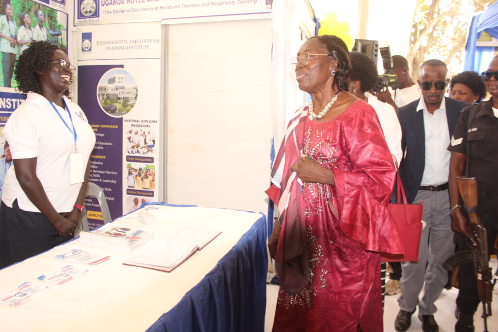 Kadaga graces 14th NCHE expo, roots for copyrights law Kadaga interacts with a UHTTI exhibitor. Courtesy photo.